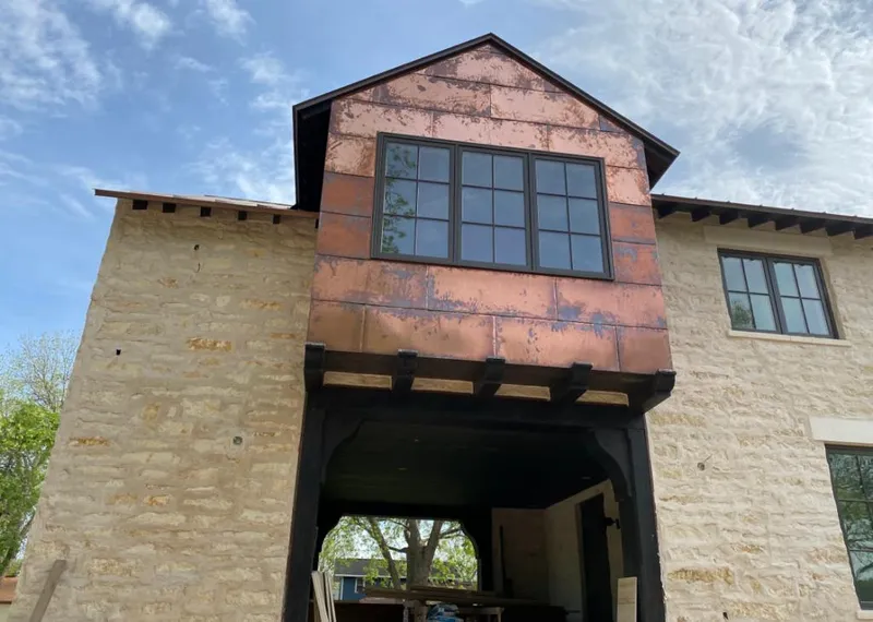 Copper metal panel facade on a stone building for Metal Roof Coating in Willmar