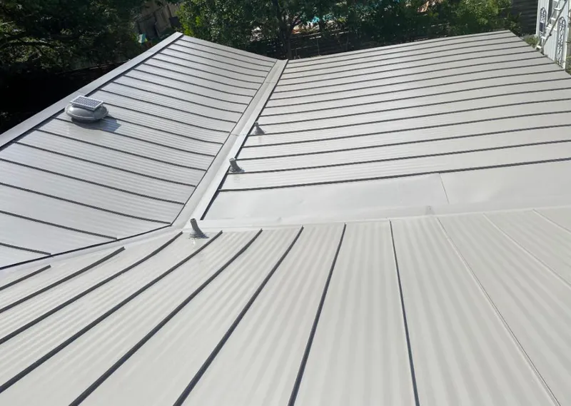 Solar attic fan installed on a metal roof for Roof Ventilation in Willmar