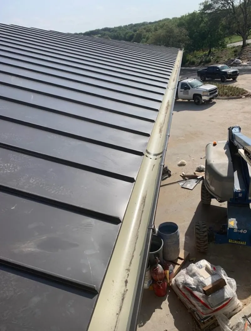Standing seam panel and gutter detail on a metal roofing jobsite in Willmar